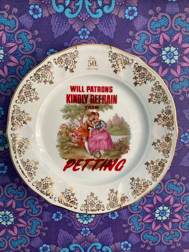 Decorative vintage plate featuring a young 'courting' couple with the slogan 'Will patrons kindly refrain from petting' across the plate.