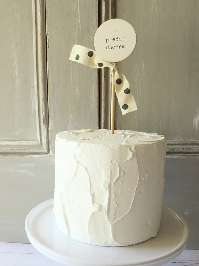 wooden circle shaped cake topper with hand painted message and custom ribbon
