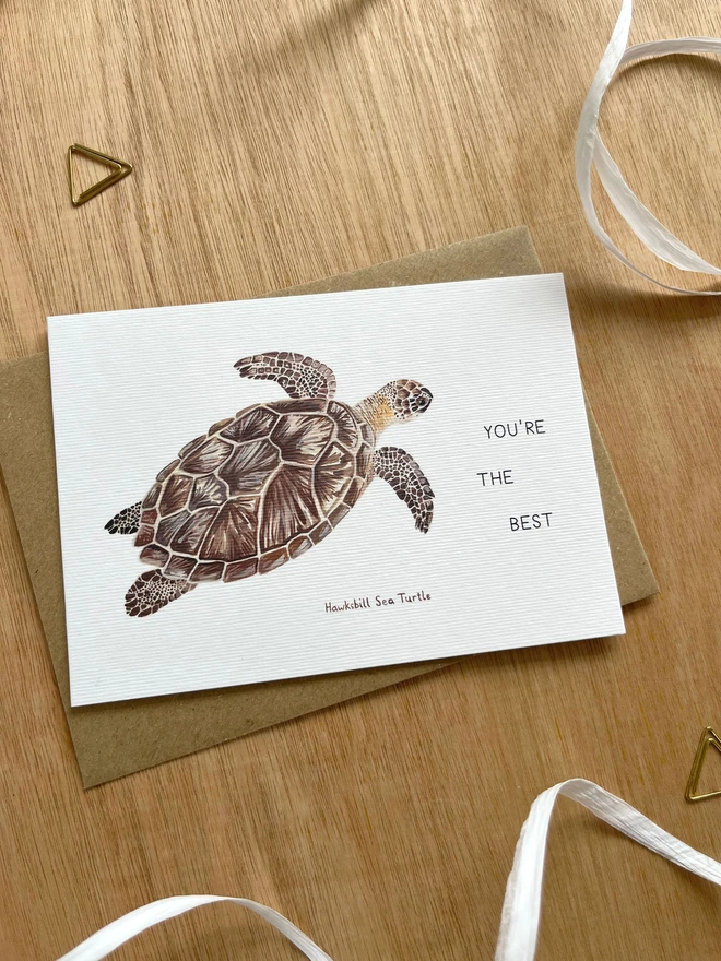 a greetings card featuring an illustration of a sea turtle with the text “You’re The Best”
