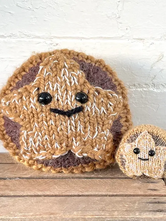 large and mini knitted mince pies with smiling faces