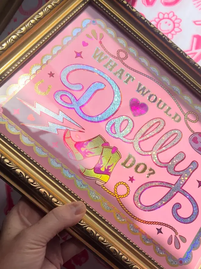 'What Would Dolly Do?' ScreenPrint, a colourful screenprint that says 'what would Dolly do?' sitting on a decorated surface. 