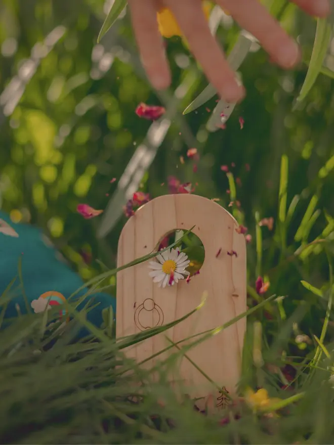 child playing with wooden fairy door
