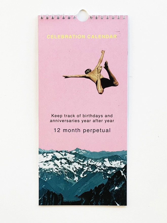 The front cover of a perpetual art calendar featuring a person jumping above the mountains against a pink sky.