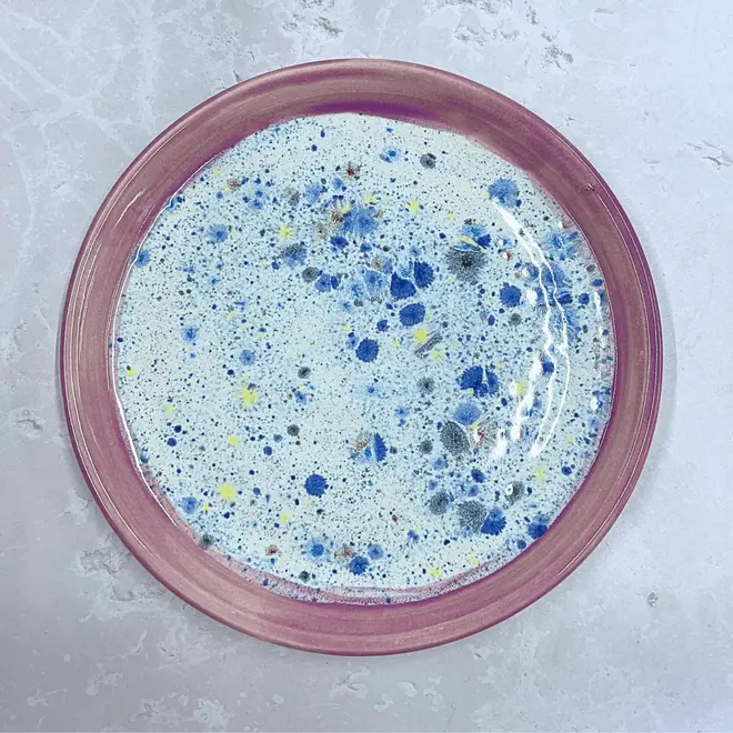 Shoreline Dinner Plate, a colourful plate placed on a stone surface. 
