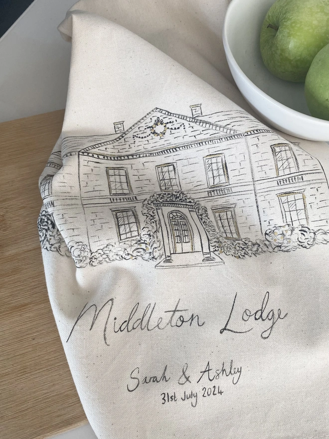 Tea towel with a hand painted venue illustration 