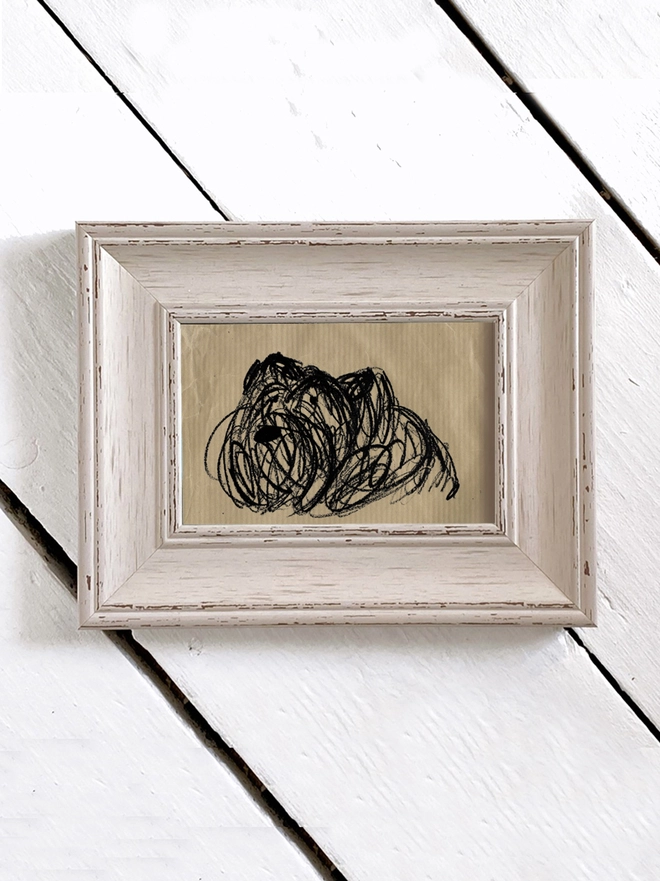 framed drawing of dog on brown paper