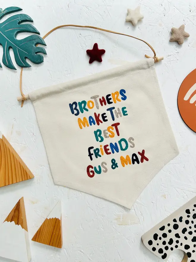 custom embroidered banner. cotton banner embroidered with 'brothers make the best friends gus and max' in colourful lettering.