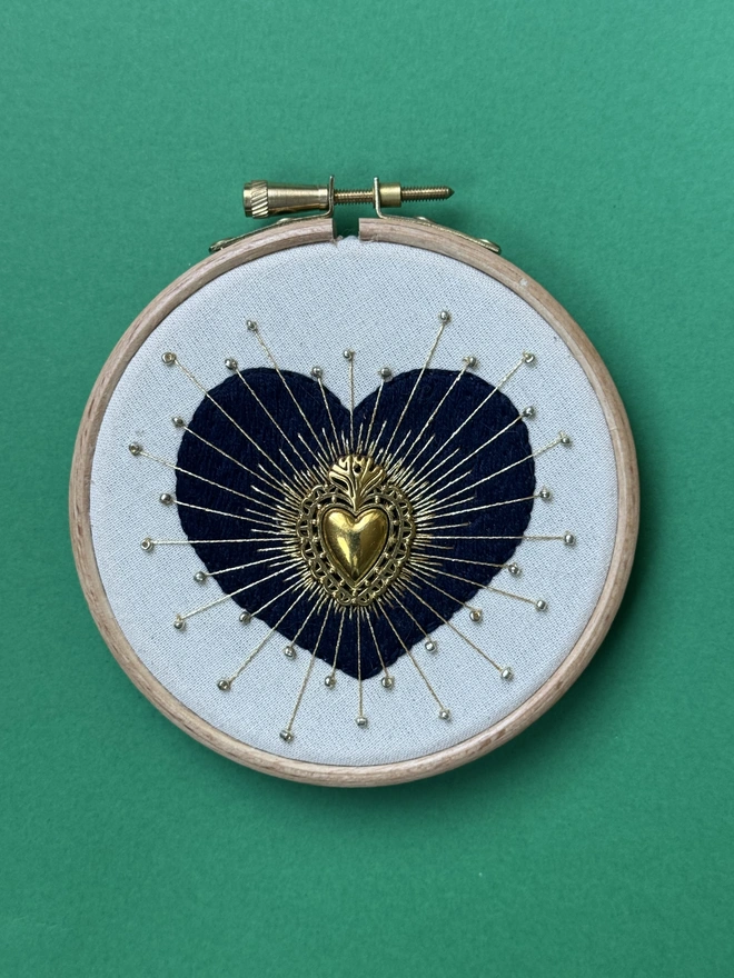 Embroidery hoop hand stitched navy heart with gold heart bead and gold floss and gold beads