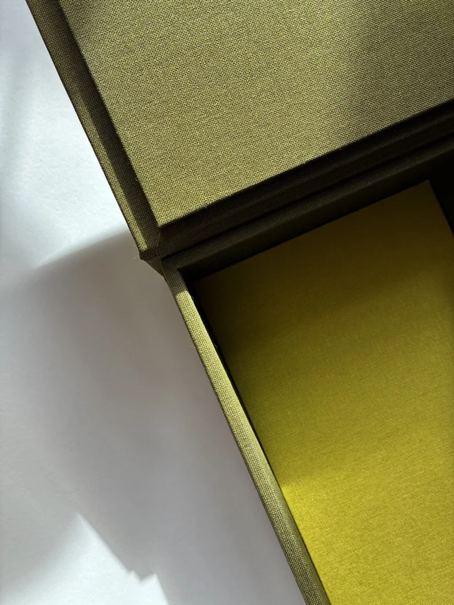 Details of open and empty handmade Christmas correspondence box covered in linen cloth with compartments