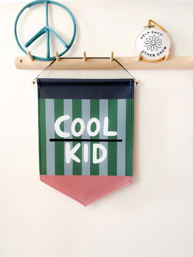 Green and blue stripe wall banner with the words cool kid 
