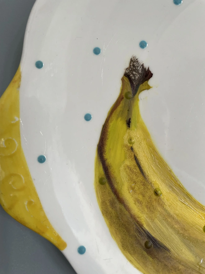 detail of banana painting on plate