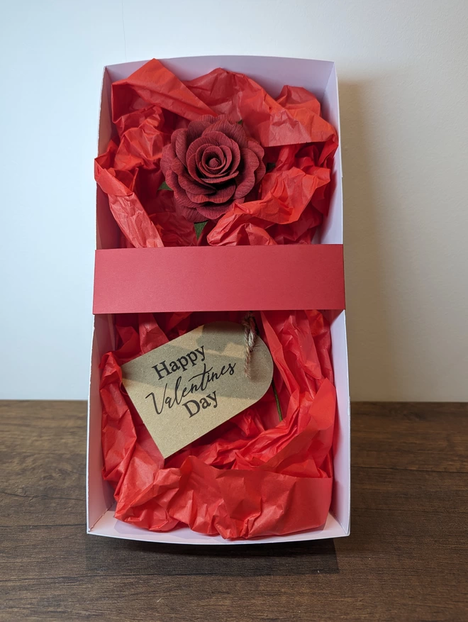 Single red rose with gift tags in handmade gift box