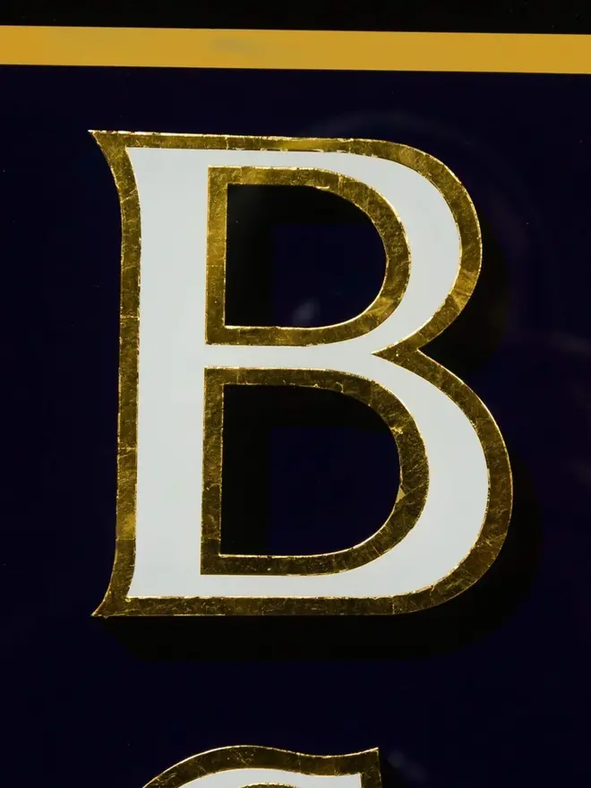 boys club hand painted sign. sign zoomed in on letter B
