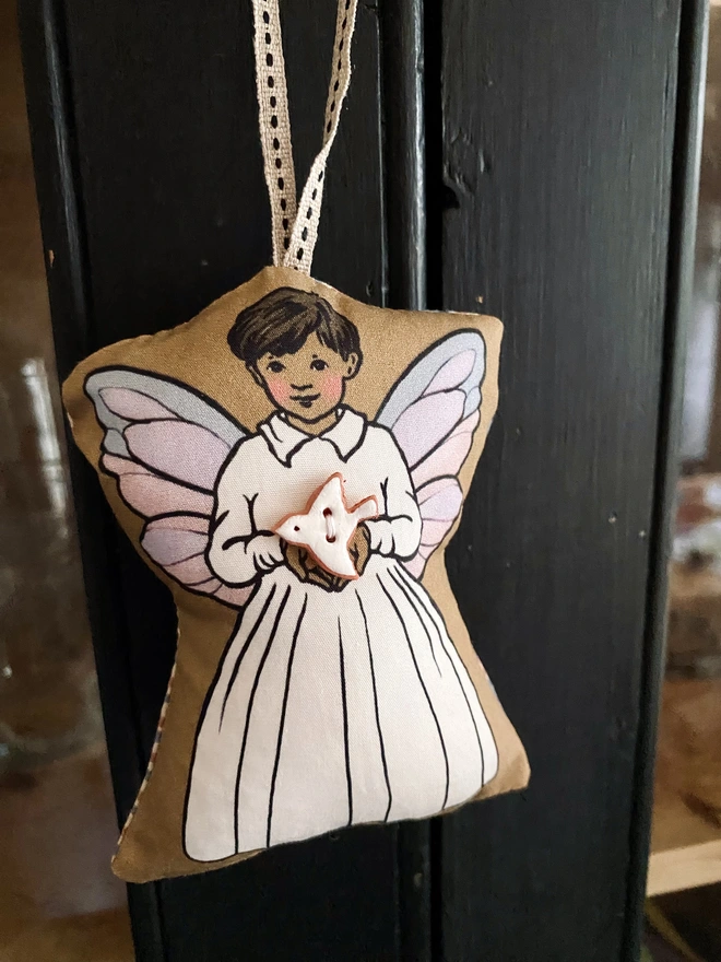 an asian boy tooth fairy doll decoration holding a peace dove button