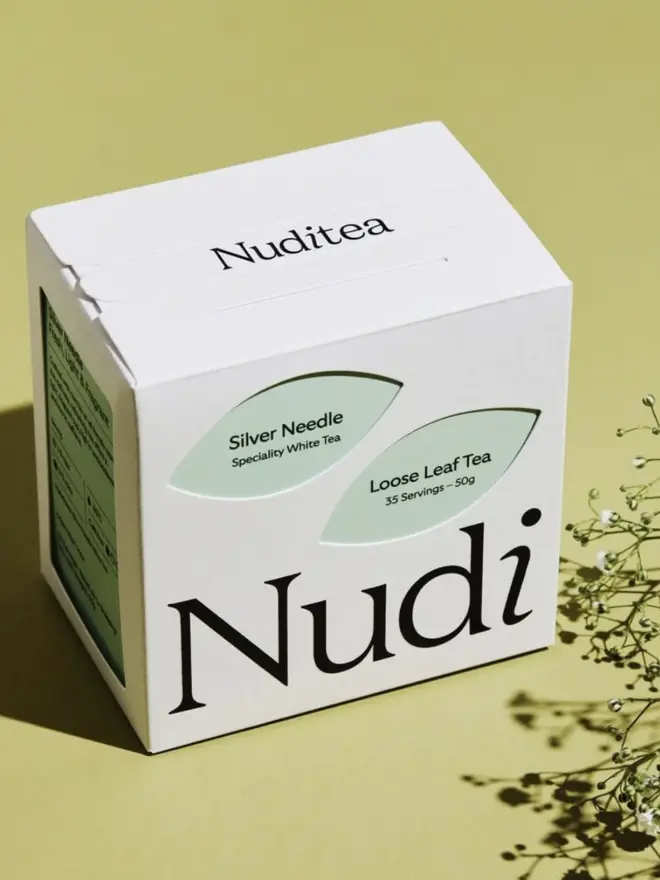 white box of silver needle tea with pale green leaf design
