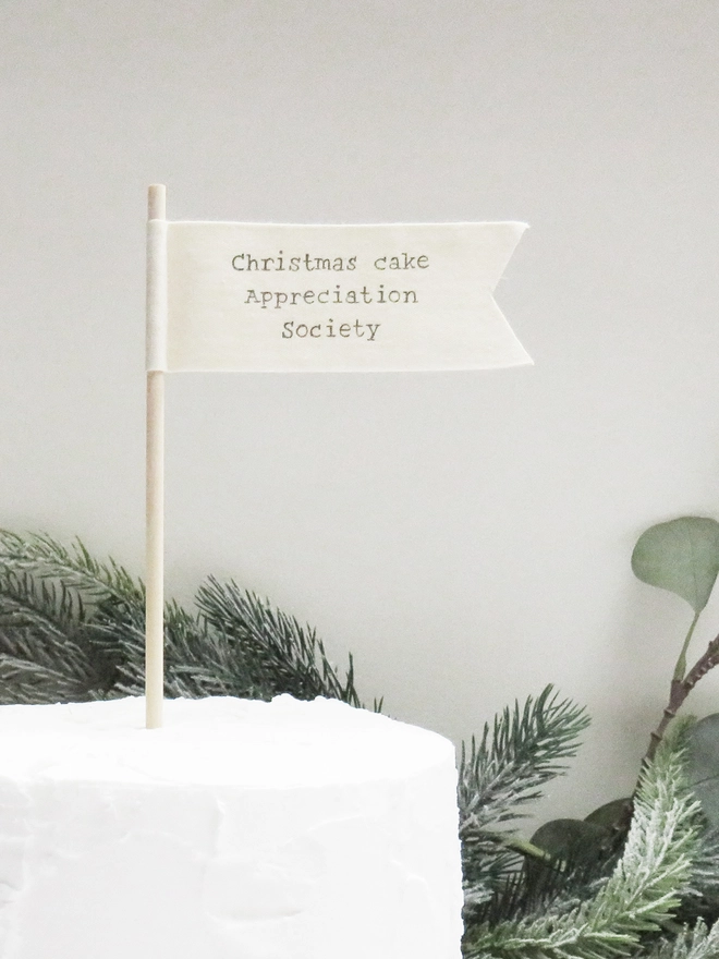 organic cotton flag with hand painted festive message wrapped round wooden dowel.