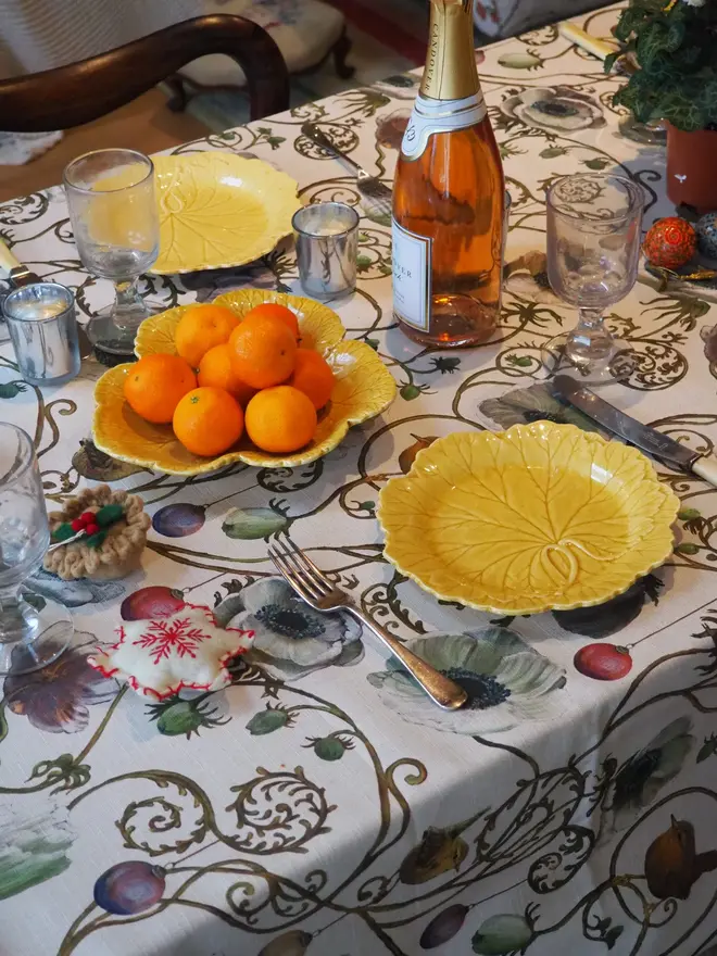 christmas robin tablecloth. a tablecloth with illustrated robins and baubles on a table.