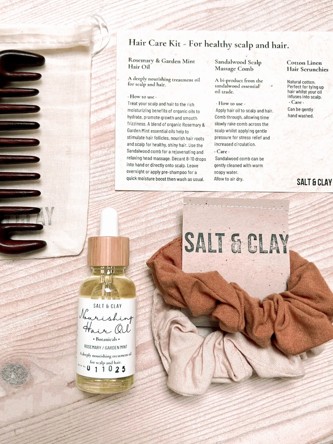 nourishing hair oil gift kit including sandalwood comb and cotton linen scrunchies.