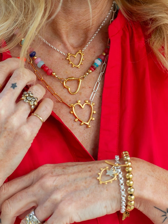 A delicate take on a bold favourite, the Mini Studded Heart Necklace pairs a textured studded heart with a timeless belcher chain. This mixed metal heart necklace is made for modern layering and everyday styling — a wearable symbol of love and personal expression you’ll reach for on repeat.