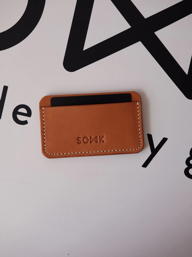 SOWK tan leather card holder.
