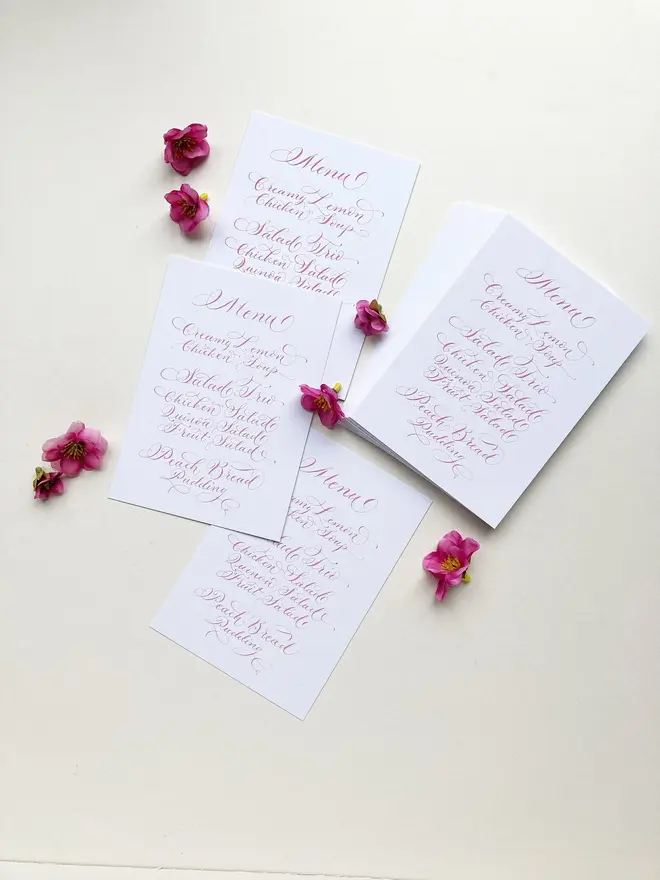 calligraphy wedding menus. white menu with pink calligraphy.