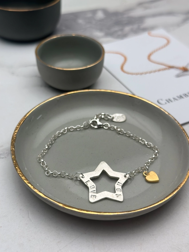 personalised sterling silver open star charm on a silver belcher chain bracelet with additional tiny heart charm in gold