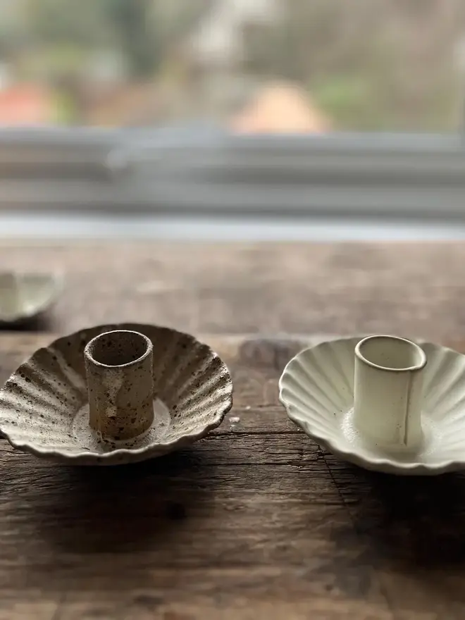 Handmade Natural Speckled Ceramic Candlestick Holder, a pair of ceramic candlestick holders sitting on a wooden surface. 