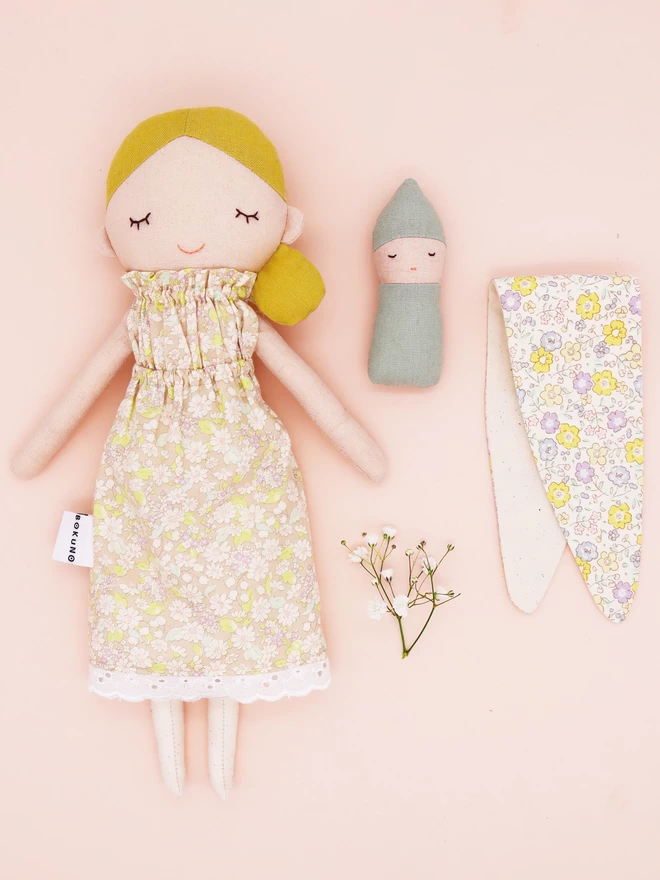 Textile mother and baby dolls with blonde hair and pale floral dress