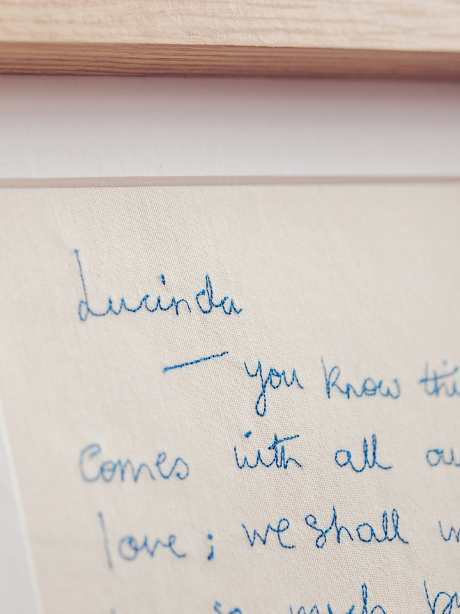 close up of embroidered handwriting in blue thread