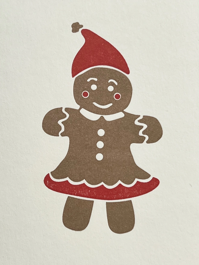 close up image of the gold and red gingerbread woman
