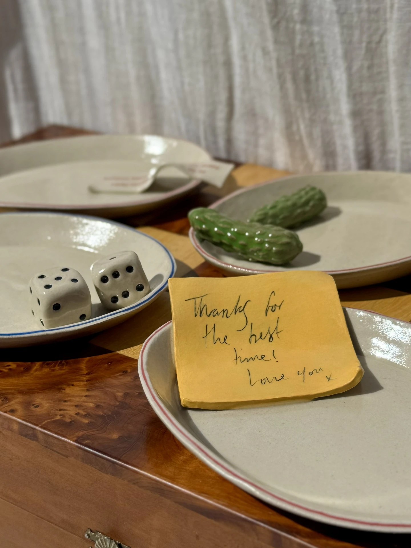 Still Life Trinket, a collection of trinkets sitting on a plate on a wooden surface.  Dish