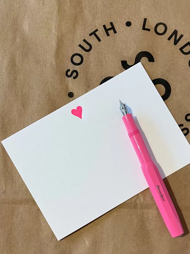 South London Letterpress Neon Pink Heart Notecard seen with a pink fountain pen.