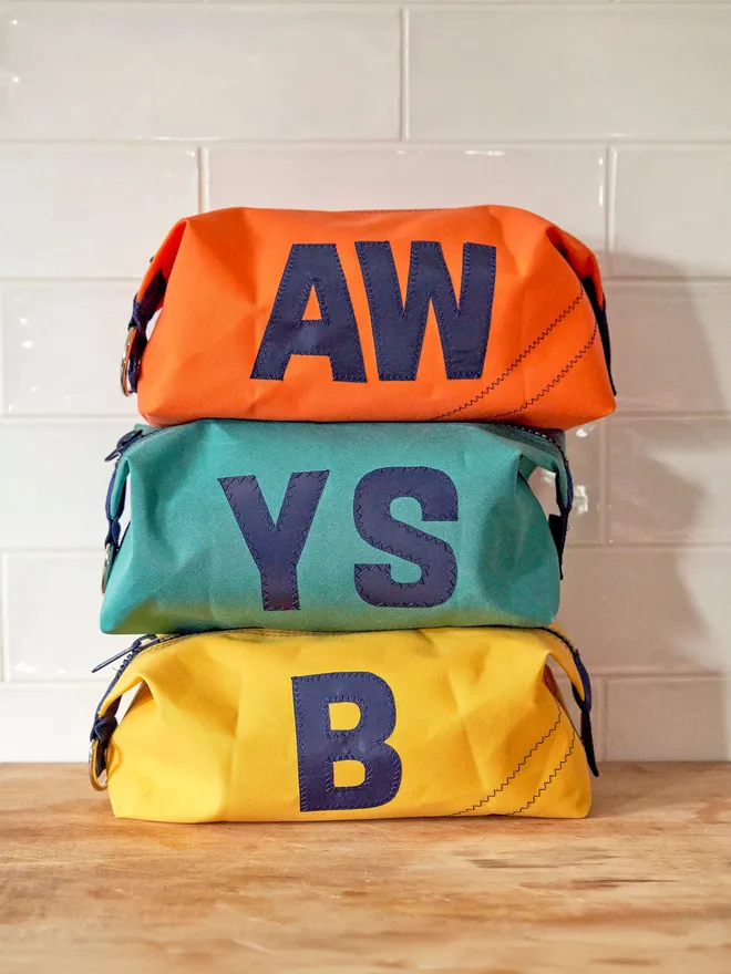 Three personalised wash bags in Yellow, Green and Orange 