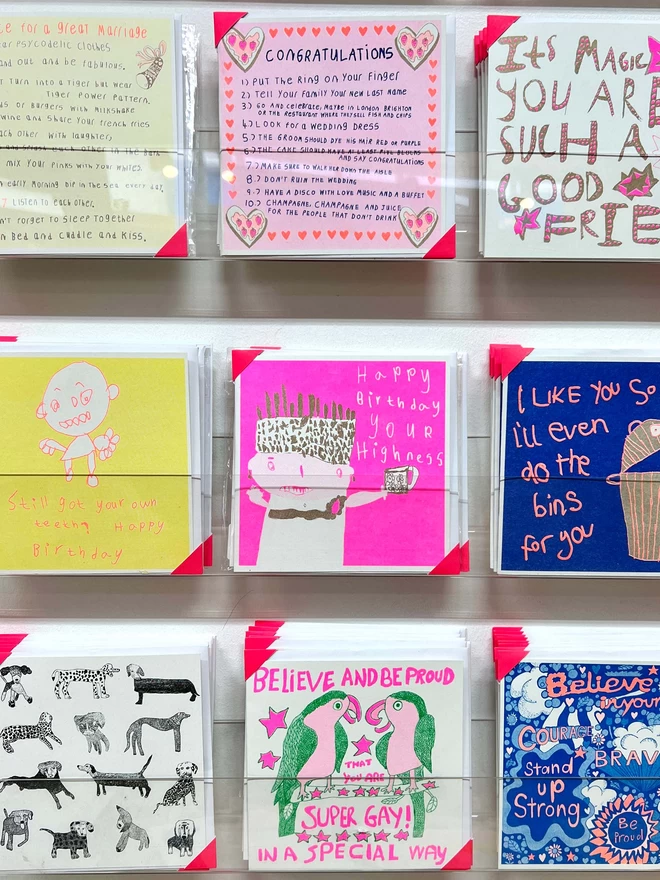 Riso printed birthday card with pink with flashes of gold that says Happy Birthday Your Highness on a rack 