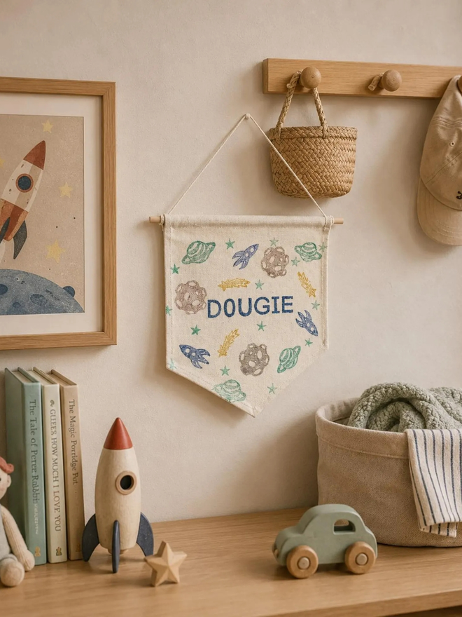 personalised space cotton wall hanging. a cotton banner on a bedroom wall.