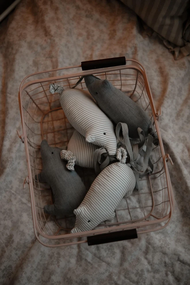 Pig Garland Decoration, a grey and white pig garland decoration in a child's bedroom. It is accompanied by other bedroom accessories. 