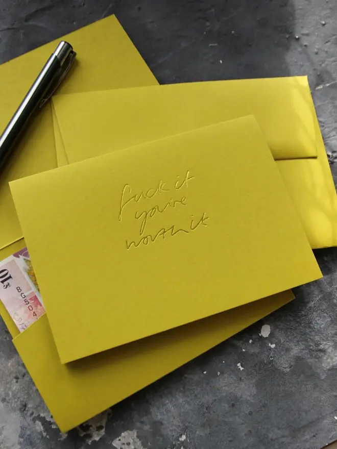 Hand foiled cash card or money wallet in a chartreuse green colour handfoiled in shiny yellow foil text which says ‘Fuck it you’re worth it’.