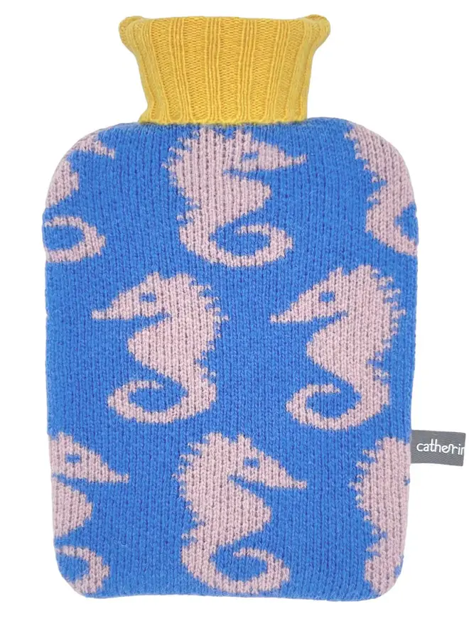Mini Lambswool Hot Water Bottle Cover, a mini water bottle sitting on a white plain surface. 