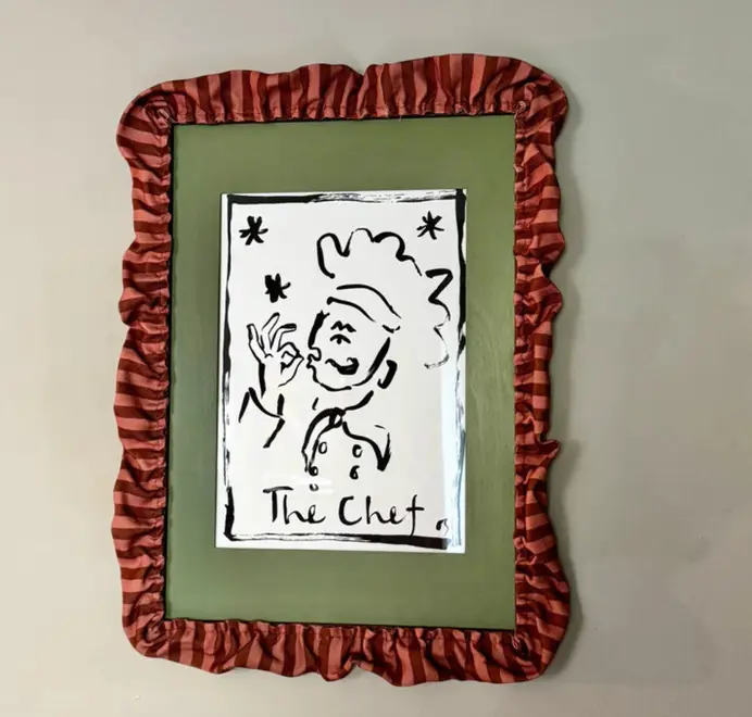 picture frame with red striped ruffled border framing green mount and picture