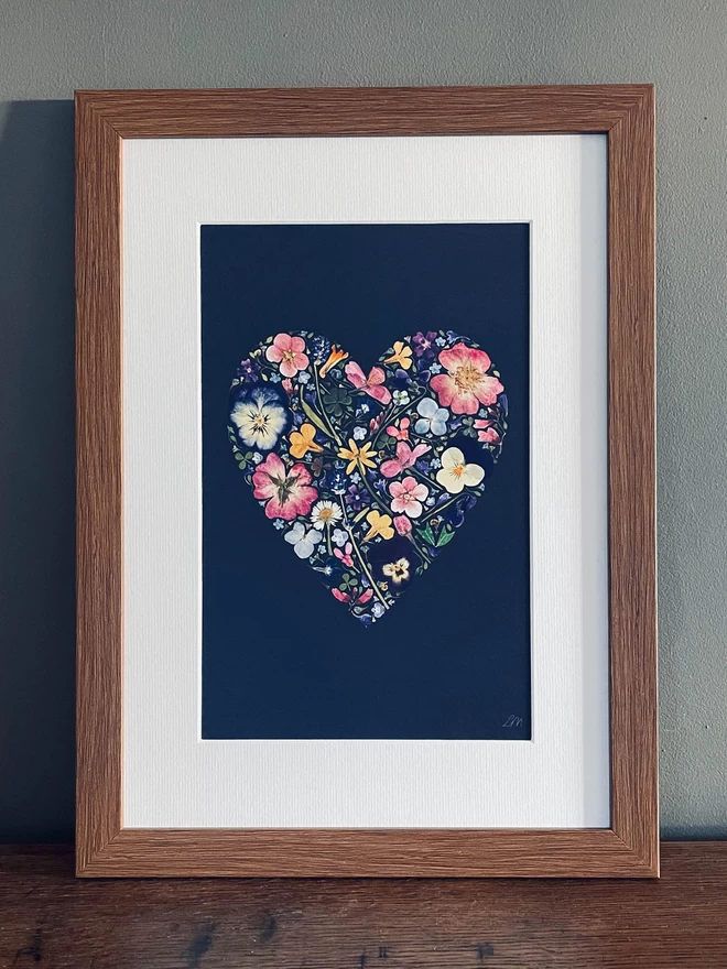 Pressed flower art print in the shape of a romantic heart.