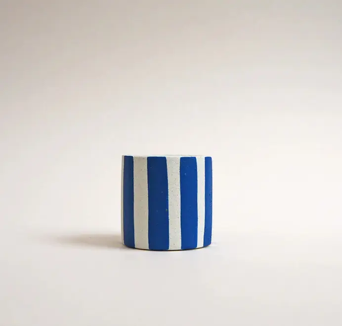 Mini Stripy Plant Pot. A white ceramic pot with vertical coloured stripes set against a plain light background.
