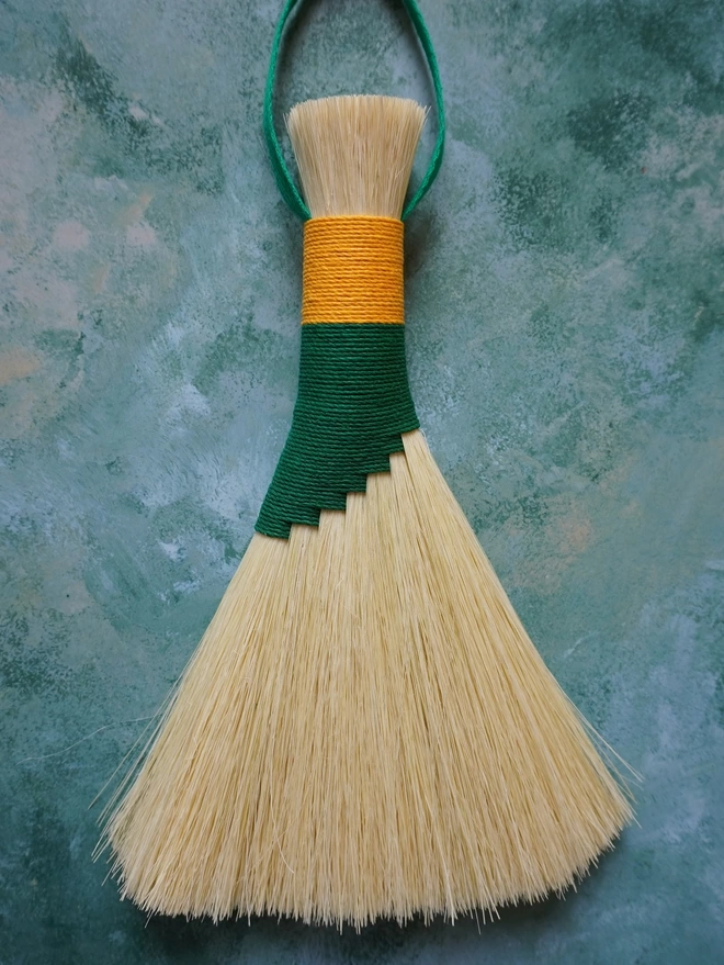 Handmade tampico brush with green and gold hemp cord binding