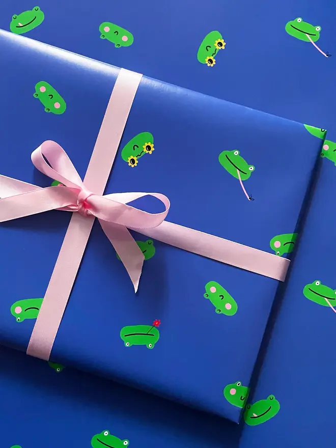 blue and green frog illustrated wrapping paper