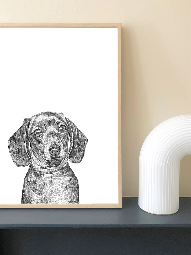 Art print of a hand drawn illustration of a dachshund displayed in a frame