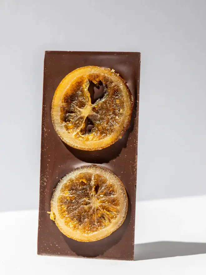 Orange Confit Chocolate Tablette standing on a white table. 