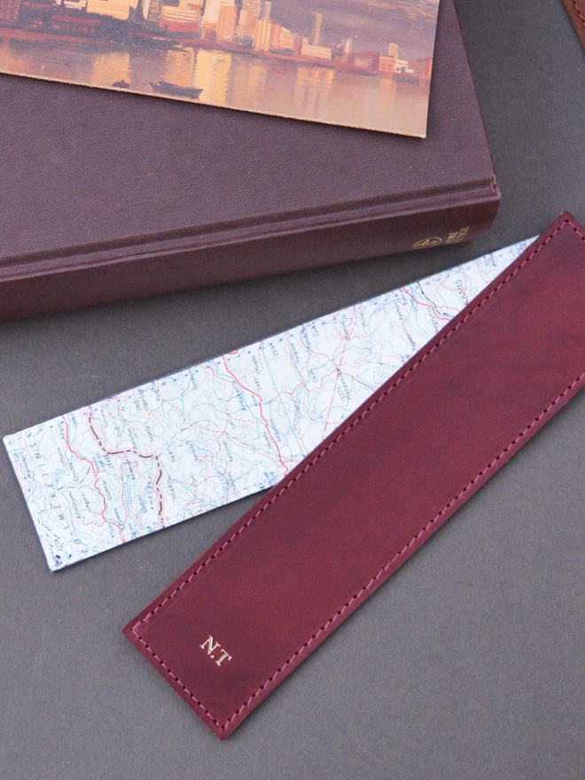red leather bookmark lined with an original silk map from the cold war available to be personalised with a name or initials