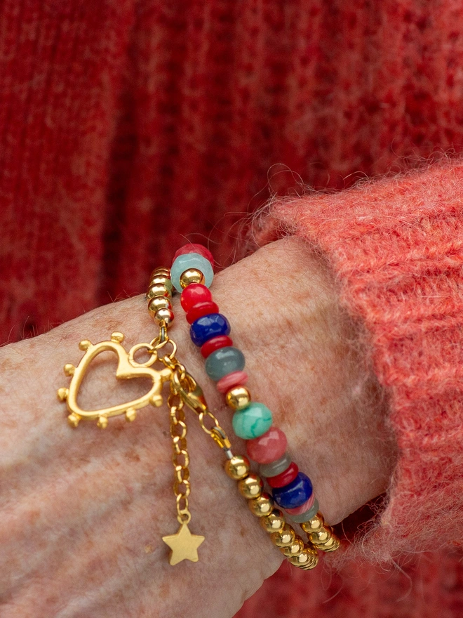 The Love Drunk Wrap Bracelet is a playful mix of colour, texture and shine. Featuring vibrant jade beads, sleek metal accents and sweet heart and star charms, this double wrap bracelet makes a thoughtful gift or joyful self-treat — a feel-good piece designed to brighten every outfit.