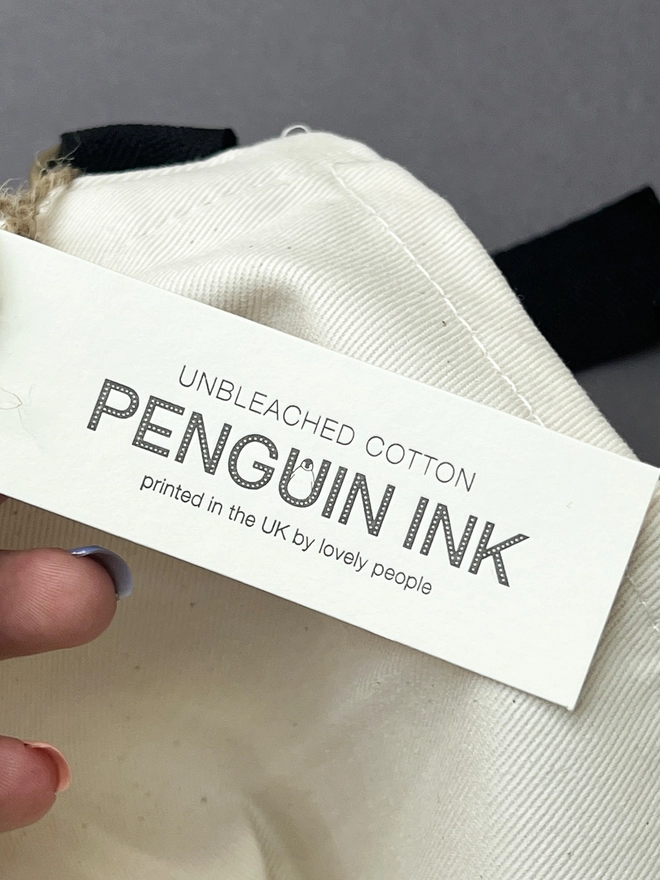 Our letterpress printed swinging tag with the Penguin Ink logo