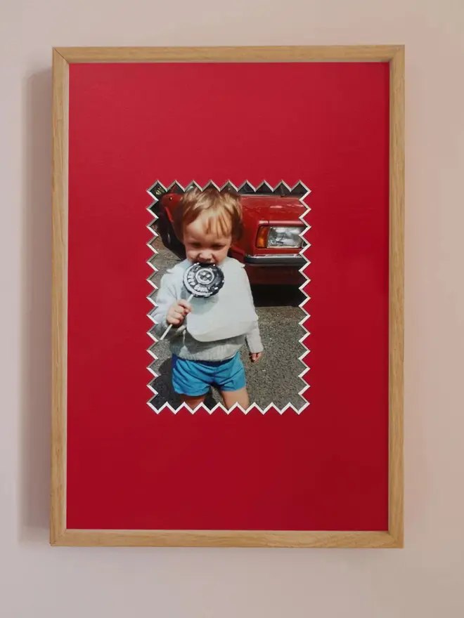 Ziggy photo mount frame ,displaying a centered portrait photo, hung on a neutral beige wall.