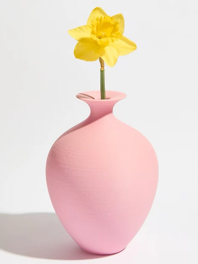 pink 3d printed vase in urn shape with yellow flower